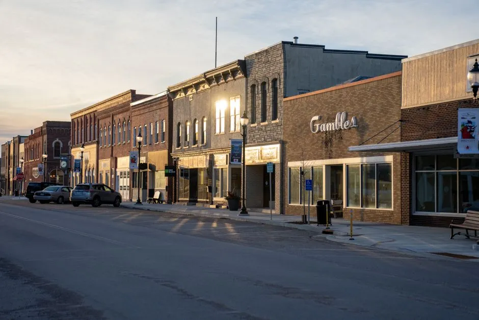 Storefronts along a small-town main street in the early evening light
